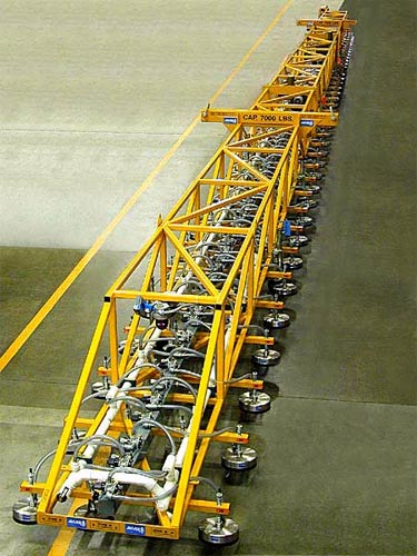ANVER Electric Powered Vacuum Lifter with an overall length of 108 feet (42.5 m) and a total of 160 Vacuum Pad Suspensions  for Lifting Extra Long Very Porous Loads weighing up to 7000 lb (3180 kg)